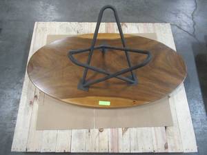 Solid Wood Elliptic Walnut Coffee Table With Metal Star Base  Approximate Dimensions 48 x 25 x 2 - Slight Scratch and Dent, Slight mold growth from sitting in warehouse (can be sandedremoved) NO RESERVE