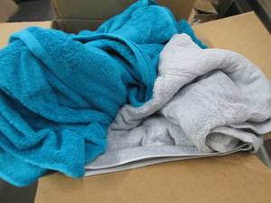 box of green and grey bath towels ...