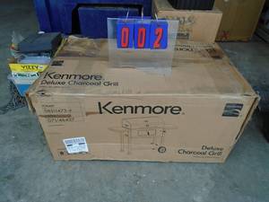 Kenmore deluxe charcoal grill. Appears new in box. Needs assembly. As shown.