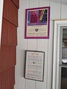 lot 110 image: Framed Wall Art Life Tips...from Dogs by Jennifer Pugh and LGBTQ March Poster