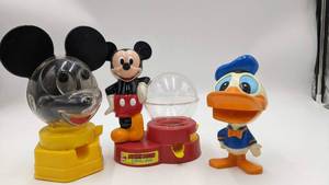 lot 39 image: Very Vintage 1960s,70s, and 80s Mickey Mouse and Donald Duck Collectibles-1968 Mickey Mouse Bank  1970s Mattel Talking Donald Duck  1986 Mickey Mouse Gumball Machine