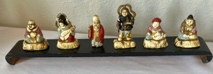 Small Asian Figurine Collection on Decorative Stand