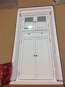 lot 37 image: Hampton Harbor 25 in. W x 14 in. D x 52-12 in. H Linen Cabinet with Drawer in White by Home Decorators Collection Customer Returns See Pictures