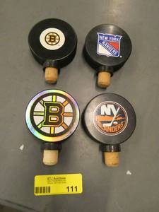 FOUR hockey puck wine stoppers