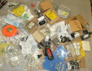 Box full of various industrial supplies, S hooks, breakers, counter, switches, etc