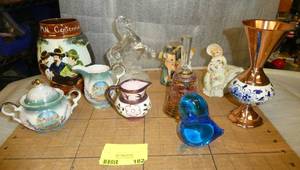 Collection of items, beer mug, glass hores, Mt Rushmore cream and sugar, Art glass bird paperweight, vintage bambi and southern bell, and unique copper vase - all are free of any damage