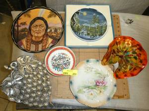 A wide range of plates, tin indian, metal grapes, a 70s Christmas plate, a very old antique plate and a art glass platedish