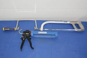Two hand saws and caulk gun