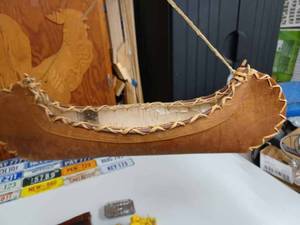 lot 10 image: Birch Bark Canoe 14-inches Long and 2-inches Deep, 27 Minature License Plates