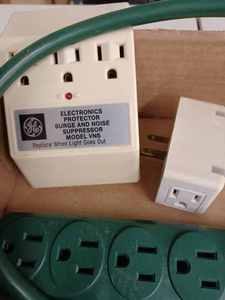lot 40 image: Box of Electric Timers, Adapters, Surge Protector, and a 5 qt. Pail of Cords and Coax