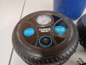 lot 42 image: Sharper Image Tire Shaped DC 12-Volt Air Compressor, a Valvoline Picnic Jug