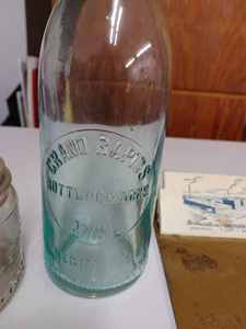 lot 76 image: Four Vintage Items including a Grand Rapids, Minn. Bottle, Plastic Meat Tenderizer from Cokato, Minn.