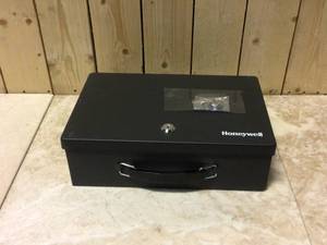 lot 27 image: Honeywell 0.18 cu. ft. Fire Resistant Steel Security Box with Key Lock Customer Returns See Pictures