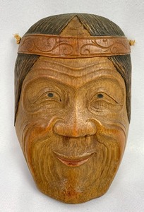 lot 28 image: Carved Antique Wooden Mask Smiling, Wrinkled Face, Dark Hair, Headband
