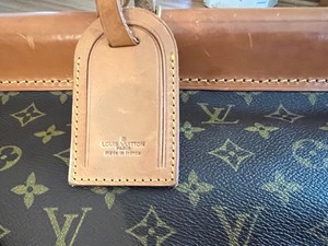lot 48 image: Large Louis Vuitton Leather and Canvas Luggage Bag
