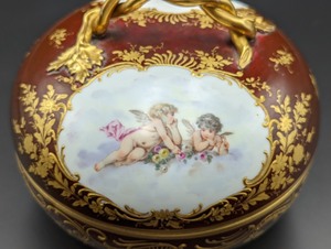 lot 29 image: Painted Porcelain Cherub Footed Trinket Box