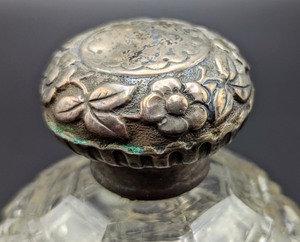 lot 54 image: Vintage Floral Embossed Silver Topped Perfume Bottle