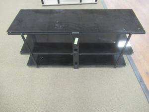 lot 222 image: Signature Design by Ashley Rollynx TV Stand, W326-10 - Store Display (Slight Scratches on Glass).