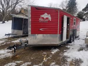 lot 1 image: 2012 Ice Castle Fish Houses The Mille Lacs Special Edition 20 Dual Axle Fish House V-Nose Trailer