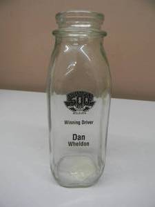 lot 26 image: INDIANAPOLIS 500 DAN WHELDON WINNING DRIVER REPLICA MILK BOTTLE - MAY 29TH 2011 - AWESOME PIECE - SEE PICTURES