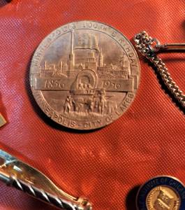 lot 27 image: Brass Cabinet Opener, Collectible Tie Clips (one dated 1949), Cufflinks, Minneapolis Centennial Coin, Plated Eagle, Ear Ring and Rings