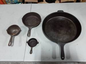 lot 29 image: 1-Large Cast Iron Pan & 3-Stamped Lodge Small Pans & Pots