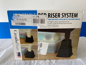 lot 32 image: CREATIVE WARE ADJUSTABLE BED RISER SYSTEM