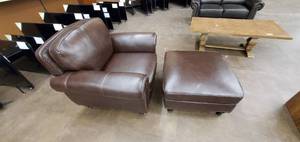 lot 736 image: Brown Leather-like Chair with Ottoman - Floor model, cosmetic damage, legs bent