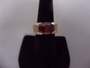 Ring-Gold Tone Band Marked 10KT With Large Red Stone Size 8