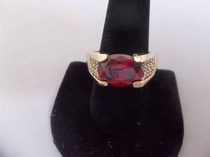 Ring-Gold Tone Band Marked 10KT With Red Stone Size 12