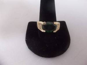 Ring-Gold Tone Band Marked 10KT With Green Stone Size 12