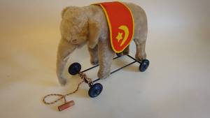 lot 15 image: Steiff Elephant Pull Toy w Button Tag on Ear...Metal Frame and Blue MetalRubber Wheels