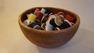lot 40 image: Wooden Bowl Filled With Spools Of Sewing Thread