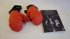 lot 346 image: Orange Boxing Gloves-Christies Mohammud Ali Memorabilia-Mohammud Ali Fight Tickets-The Greatest -THE LIP Fighting Cover Up Signed By Mohammud Ali- Etc.