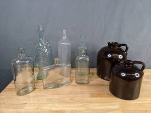lot 149 image: Collection of 2 Brown Ceramic Jugs and 5 Glass Bottles for Decor - X