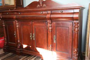Expensive Ornate Looking Dresser Or Buffet With Four Doors With Storage Shelves Inside And Three Drawers All With Hardware On Them