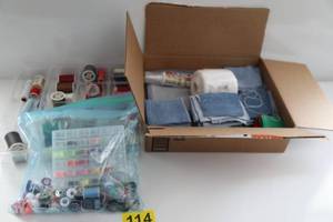 Container Filled With Various Colors Of Thread-Bobbins Filled With Threads For Sewing Machine-Square Pieces Of Denim Quilt Pieces-Skein Of White Yarn