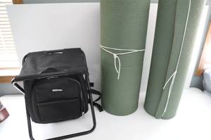 Black Canvas Fold Up Camp Stool-Black Sub Zero Cooler-Two Light Green Rolled Up Styrofoam Mattresses
