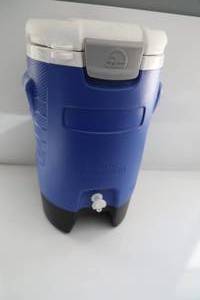 Blue Igloo Water Cooler With White Lid And With Spicket On Front To Disperse Liquid