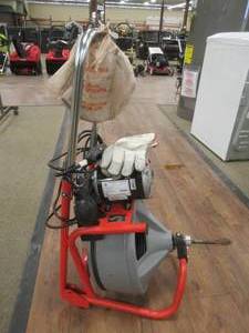 lot 831 image: RIDGID K-400 Drum Machine for 1-12 in. to 4 in. Drain Lines - Missing Bar that attaches the wheels - Works Well, cuttersgloves Included.