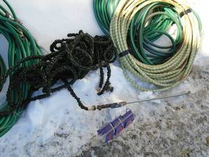 Large qty of garden hoses & expandable hoses with nozzle. As shown.