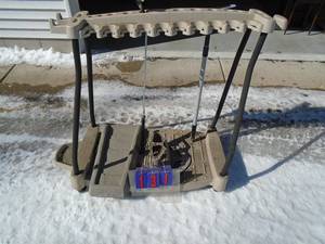 Suncast yard tool rack on castors. Holds approx 20 pieces. As shown.