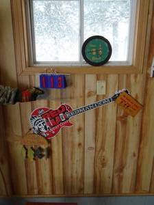All items on wall. Includes deer clock & red man tin guitar. As shown.