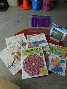 Flat of coloring books & exacto pencil sharpener. As shown.