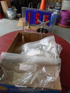 Lionel crossing pt. no. 158.9,154. Made in usa & lionel lighted lamp post # 58-19. Made in usa. Both metal. As shown.