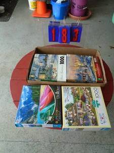Box of 4 new puzzles. As shown.
