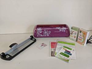 lot 110 image: 24 Cricut Expression Personal Cutter-Never Used, WORKS , 2 Font Cartridges, Paper Cutter, Replacement Blades, User Manual, Extra HP Paper