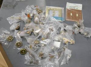 lot 143 image: Group of hardware - drawer pulls, knobs, light switch plates