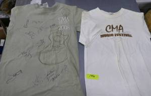 lot 196 image: Autographed CMA music festival shirts - the white shirt is stained, quite a few autographs tho