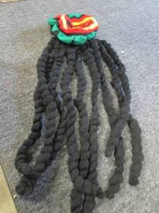 box of hats with attached dreadlocks...